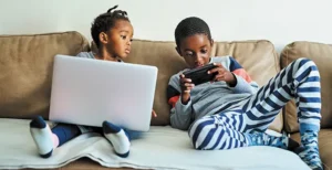 Niño usando dispositivos digitales y su impacto en el desarrollo cerebral infantil